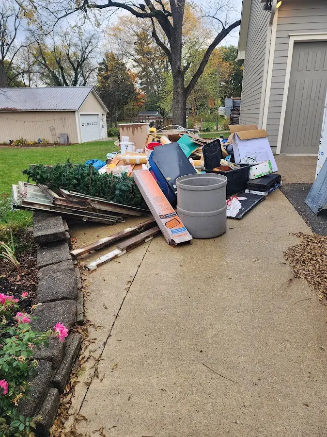 Dumpster being loaded with debris for Estate Cleanout Dumpster Rental in Towson